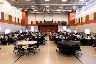 gym for website course participants raise their arms during a teacher organization workshop